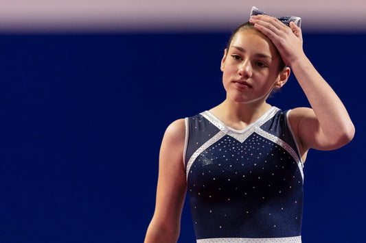 Gymnast holding her head in her hands